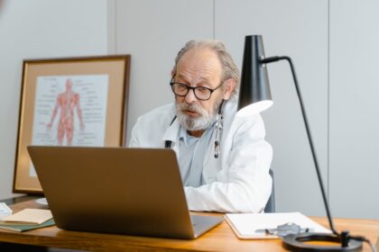 Photo by Tima Miroshnichenko: https://www.pexels.com/photo/an-elderly-man-in-white-lab-coat-talking-while-facing-the-laptop-8376291/