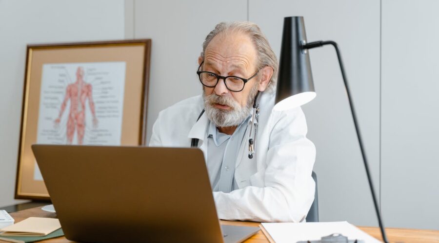Photo by Tima Miroshnichenko: https://www.pexels.com/photo/an-elderly-man-in-white-lab-coat-talking-while-facing-the-laptop-8376291/